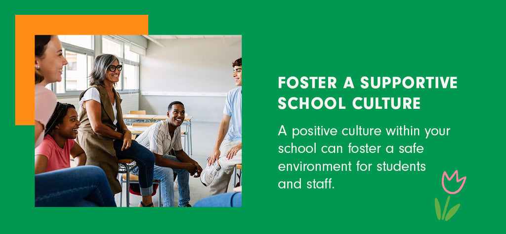 A principal sits on a desk and talks with a group of high school students