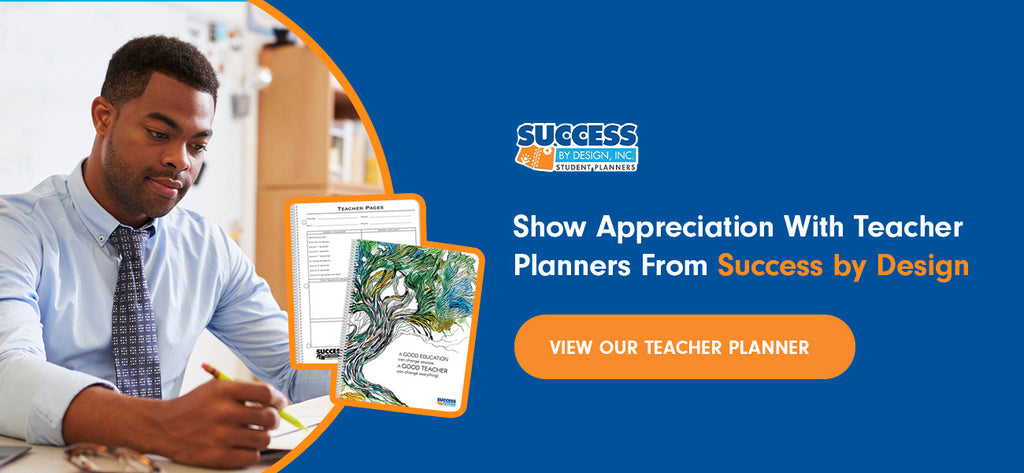 An educator uses a teacher planner at a desk